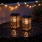 Set of 2 11"H Black Metal Cutout Pattern Solar Powered Hanging Lantern with LED Light